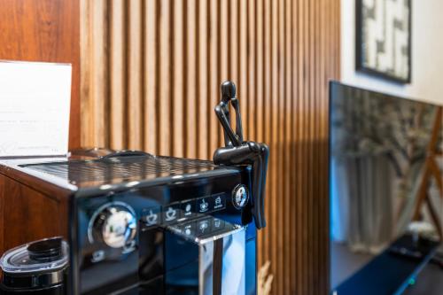 a black toaster oven sitting on top of a counter at Designer 1 Bedroom Apartments in Dubai Hills Estate in Dubai