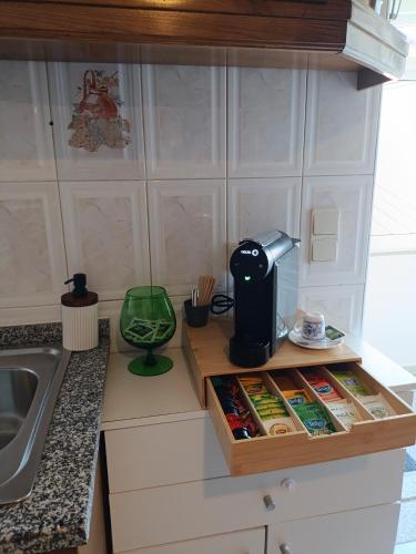a kitchen counter with a coffee maker and a box of food at Casa D'avó in Sabrosa
