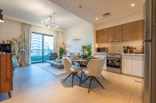 a kitchen and dining room with a table and chairs at Designer 1 Bedroom Apartments in Dubai Hills Estate in Dubai