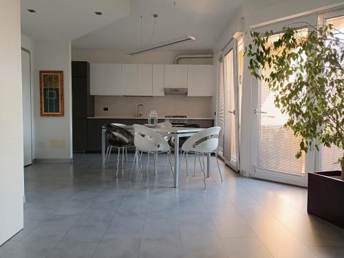 a kitchen and dining room with a table and chairs at Domò in Domodossola
