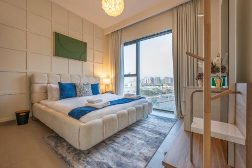 a bedroom with a large bed and a large window at Designer 1 Bedroom Apartments in Dubai Hills Estate in Dubai