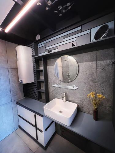 a bathroom with a sink and a mirror at SpitzBergen house in Oryavchyk