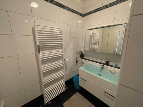 a bathroom with a sink and a mirror at Casa Pelzerro in Aachen