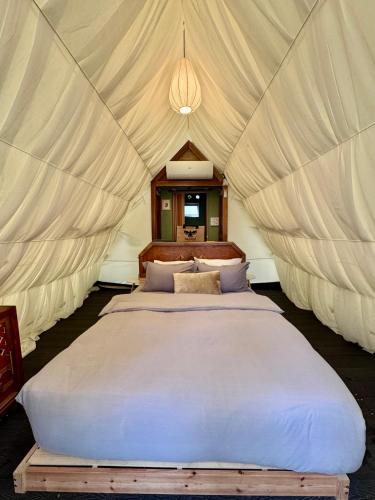 a bedroom with two beds in a tent at eagleye glamping langkawi in Pantai Kok