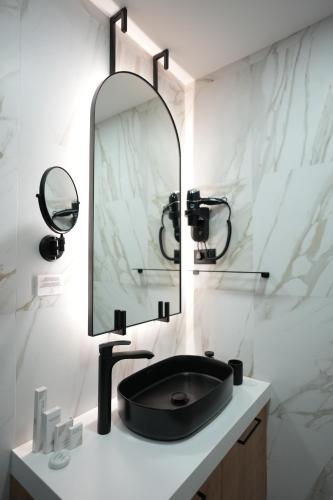 a bathroom with a black sink and a mirror at Madera apartments in Čačak