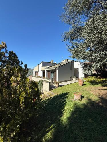a house on a hill with a grass yard at Castelvetri B&B in Castiglione dei Pepoli