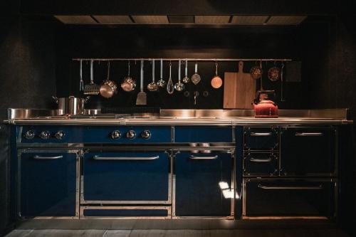 a kitchen with a stove and a counter top at Historic Alpine Lodge In The Heart Of South Tyrol in Villandro