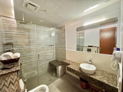 a bathroom with a sink and a toilet and a mirror at Modern 1 bedroom apartments in DHA in Lahore