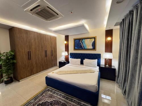 a bedroom with a large bed in a room at Modern 1 bedroom apartments in DHA in Lahore