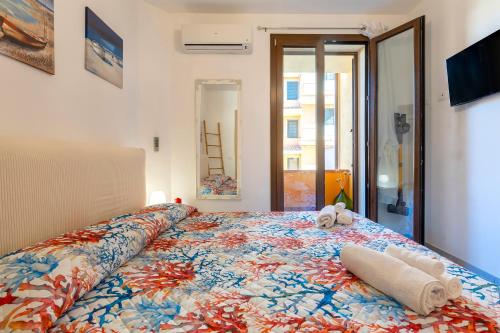 a bed with two stuffed animals sitting on top of it at Petra Maris in Castelsardo