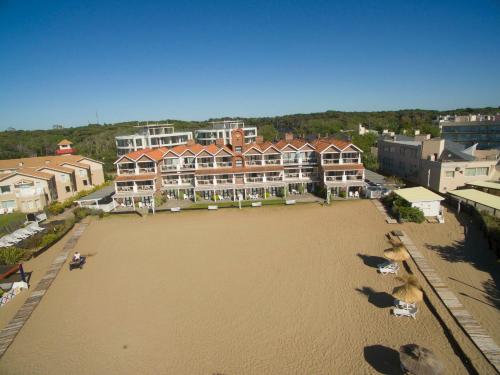 an aerial view of a large beach with houses and condos at Carilo Soleil By HS in Carilo