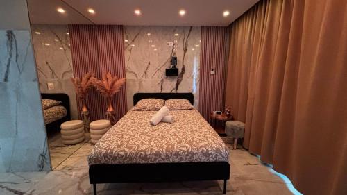 a bedroom with a bed with two white pillows on it at L'Écrin Secret Romantic Love Room & Private Spa in Ambilly