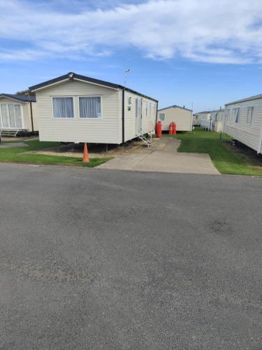 an empty parking lot in front of a mobile home at 3 Bedroom Static Caravan, Sleeps 8, New 2025! in Hartley