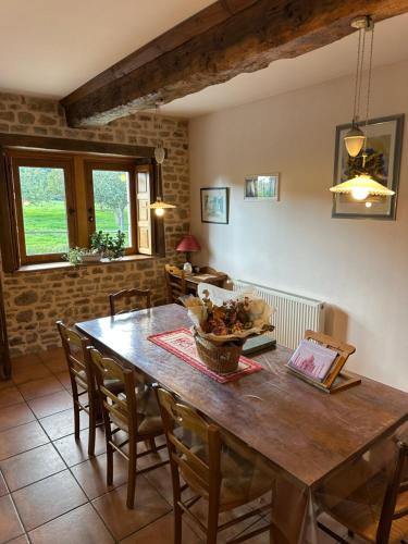 a dining room with a wooden table and chairs at Gîte/Guest House close to the Mont Saint Michel in La Rochelle-Normande