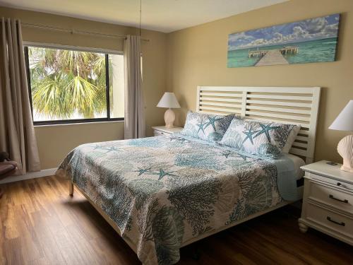 a bedroom with a bed and a large window at Book Me Baby! Bayview Beauty at Siesta Key in Siesta Key