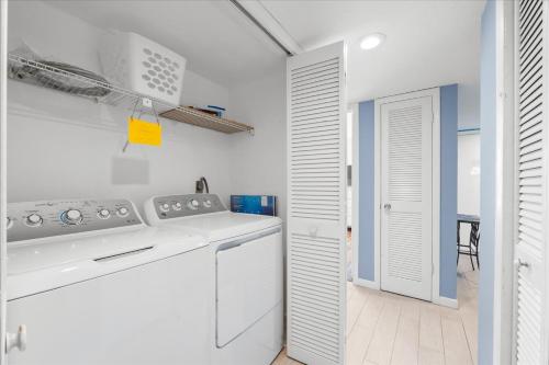 a white kitchen with a stove and a dishwasher at Book Me Baby! Bayview Beauty at Siesta Key in Siesta Key