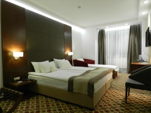 a hotel room with a large bed in a room at Central Hotel Sofia in Sofia