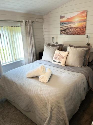 a bedroom with a large bed with towels on it at No 4 Dane Park in Lymington