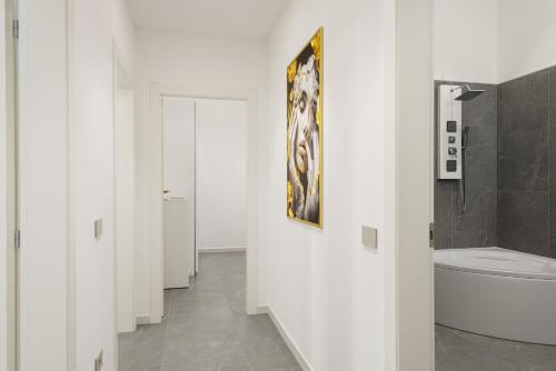 a bathroom with a toilet and a painting on the wall at Borghese Palace Luxury Apartment in Florence
