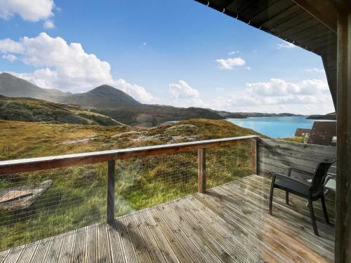 a balcony with a chair and a view of a lake at Torrin - Uk50497 in Kylestrome