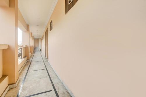 a corridor of a hospital with white walls at Hotel O Subash Inn in Jalandhar