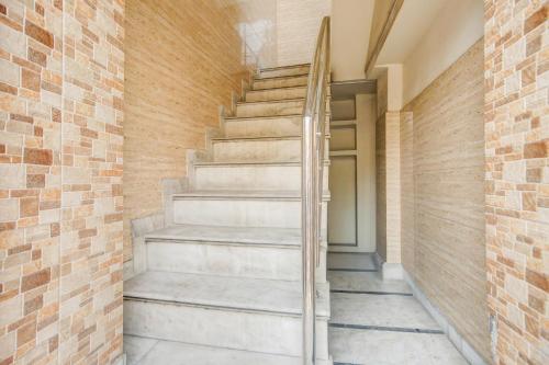 a staircase in a building with a brick wall at Hotel O Subash Inn in Jalandhar