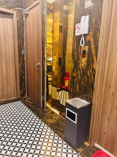 a bathroom with a walk in shower and a trash can at The Room Hotel - Starbucks in Phú Quốc