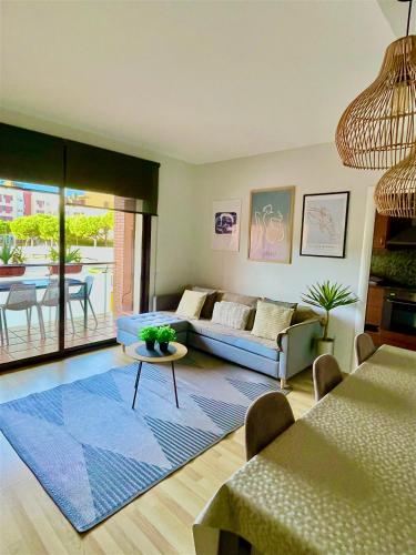 a living room with a couch and a table at FENALS BEACH&CHIC, Boutique Apartament, free parking, full equipped near the beach in Lloret de Mar