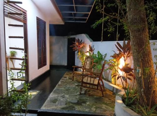 a patio with chairs and plants in a house at TaMaRiNd house in Hikkaduwa