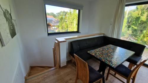 a small dining room with a table and a window at Seeblick Wohnung,Hausboot in Königs Wusterhausen