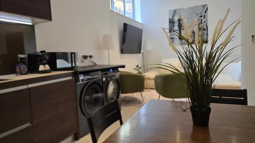 a kitchen with a washing machine in a kitchen with a table at Kings Cross St Pancras One Bedroom Flat in London