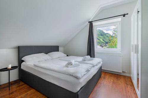 a bedroom with a large bed with a window at homy Alpenlodge in Innerbraz