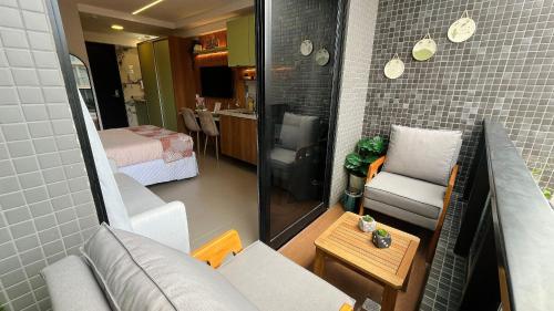 a small living room with a couch and a table at Flat à beira-mar Beach Haus - MyFlats Hospedagens in Tambaú