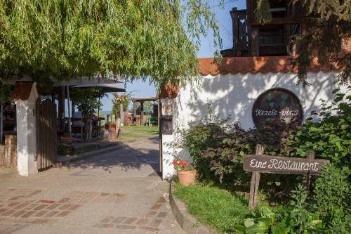a sign in front of a building with a cafe restaurant at Pension Kezele in Graberje Ivanićko