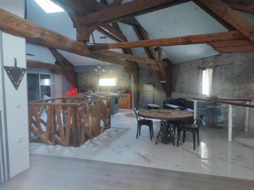 una cucina con un tavolo e sedie in una stanza di chambres dans maison vigneronne a Peyriac-de-Mer