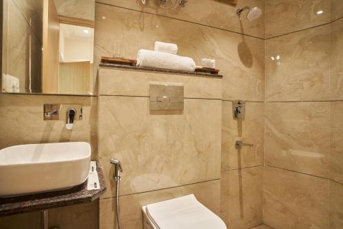 un bagno con doccia, lavandino e WC di Anvaya Udaipur a Udaipur