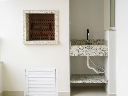 a bathroom with a sink and a mirror at Apto c/ churrasqueira a 700m da praia MU3731 in Gravata