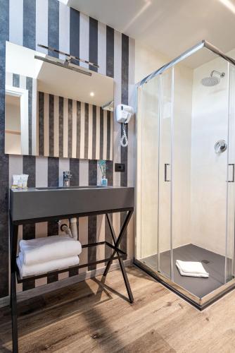 a bathroom with a sink and a shower at The Gate Hotel - Firenze Nord in Sesto Fiorentino
