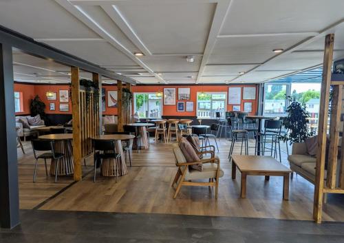 a restaurant with tables and chairs in a room at Billing Aquadrome Holiday Park in Great Billing