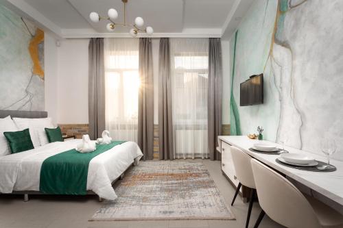 a bedroom with a bed and a table and a desk at Magister Apartmanház in Cserépfalu