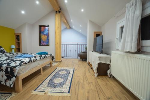 a bedroom with a bed and a tv in a room at Home Norma in Órma