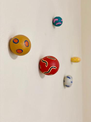 a group of balls hanging on a white wall at Gainesville Lodge in Gainesville
