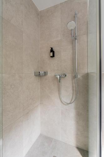 a shower with a shower head in a bathroom at homy City Diamant in Feldkirch, Grenznähe und doch Zentral in Feldkirch