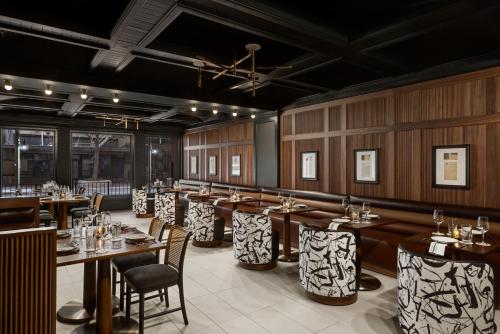 a restaurant with wooden walls and tables and chairs at The Gunter Hotel San Antonio Riverwalk in San Antonio