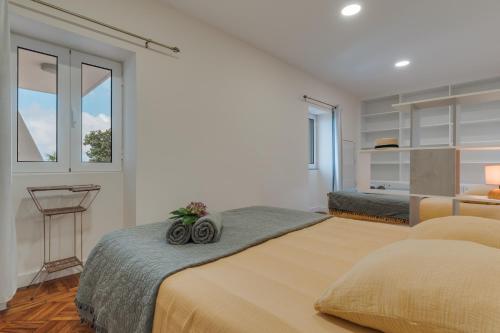 a bedroom with two beds and a window at Villa Natural Oasis with panoramic view & bio-diverse 9 950m2 garden in Funchal