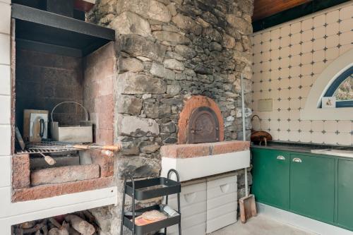 a kitchen with a stone wall at Villa Natural Oasis with panoramic view & bio-diverse 9 950m2 garden in Funchal