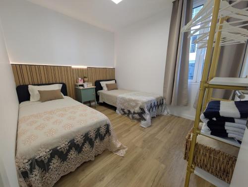 a bedroom with two beds and a ladder in it at PRINCESS FLOWER - Sea, View, Parking, Center in Funchal