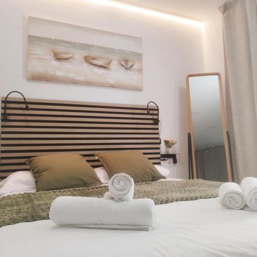 a bedroom with two beds with towels on them at GO&REST Apartments in Valencia