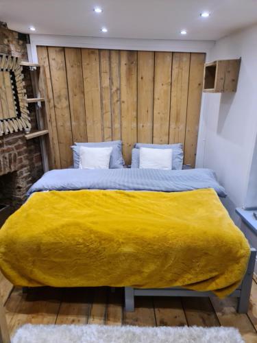 a bedroom with a large bed with a yellow blanket at Seaside hideaway st Leonards in Hastings