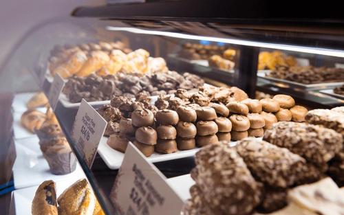 a display case filled with lots of different types of donuts at Harlow's Casino Resort & Spa in Greenville